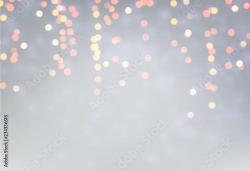 Grey blurred background with golden lights.