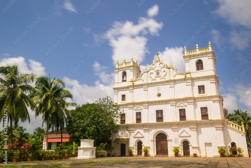 Ancient St. Thomas church landscape in Aldona Goa surrounded by monsoon clouds 