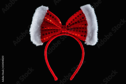 Fotografi Red ribbon over tiara in shape of minnie mouse ears isolated
