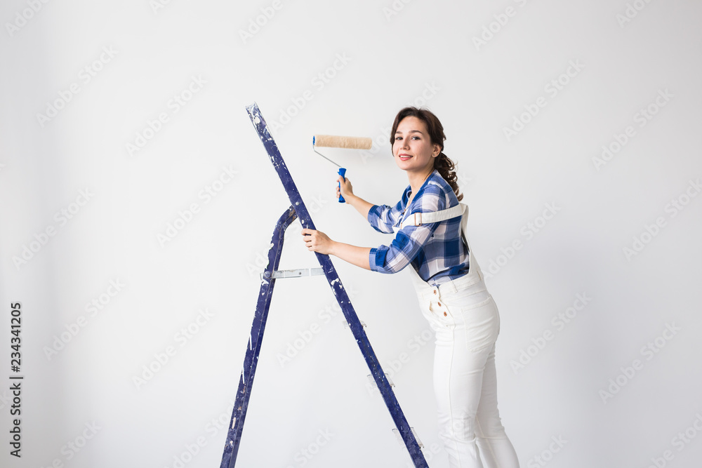 Redecoration, renovation, new home and people concept - woman painter doing repair by herself