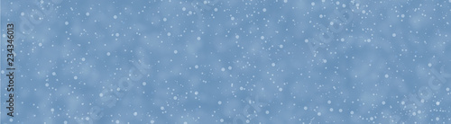 Blue abstract banner with blurred snow for winter, Christmas and New Year decorations. © Vjom