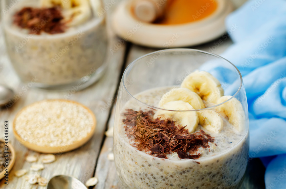 Overnight banana oats quinoa Chia seed pudding decorated with fresh banana slices and chocolate Overnight banana oats quinoa Chia seed pudding decorated with fresh banana slices and chocolate