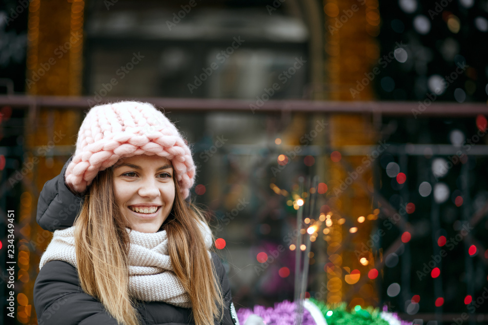 Cool blonde blonde model wearing winter outfit celebrating New Year at the street with sparklers. Space for text Cool blonde blonde model wearing winter outfit celebrating New Year at the street with sparklers. Space for text