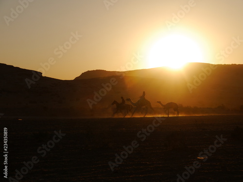 two camels and one horse riding in the sunset near Little Petra  Kingdom of Jordan