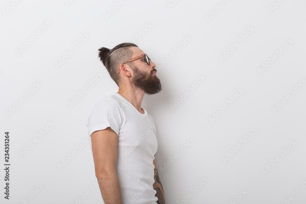 Beauty, fashion and people concept - Cool man with beard posing over white background with copy space Beauty, fashion and people concept - Cool man with beard posing over white background with copy space