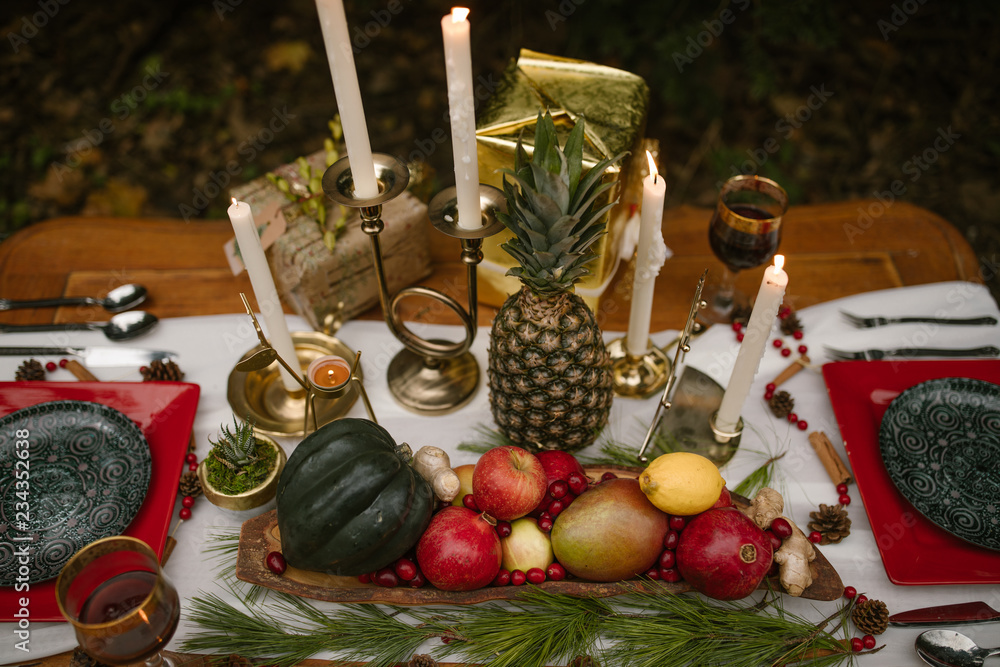 christmas still life dinner party setting with fruits and candles