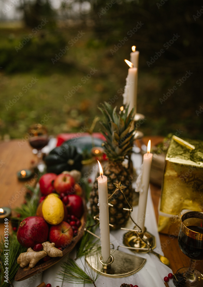 christmas still life dinner party setting with fruits and candles