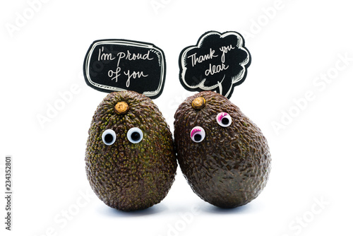 Romantic avocados couple with googly eyes and speech bubbles with text, funny food and love concept for creative projects