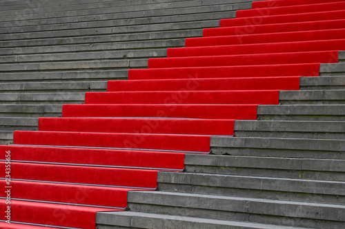 Red carpet over concrete stairs perspective