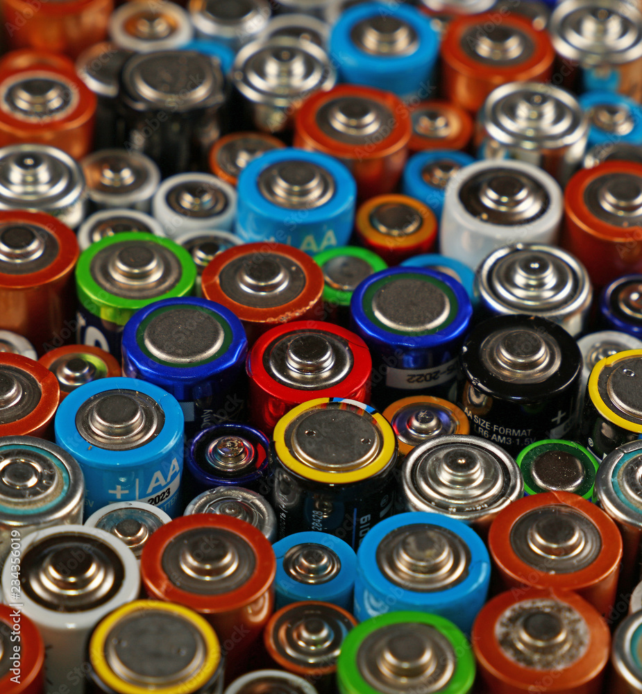 Close up background of various alkaline batteries Close up background of various alkaline batteries