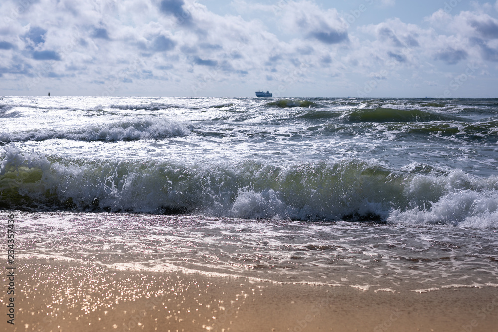 Empty beach, waves and dramatic sky at the Baltic sea shore line, Lithuania, Klaipeda