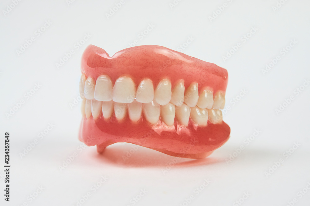 Artificial teeth on a white background with copy space. Artificial teeth on a white background with copy space.