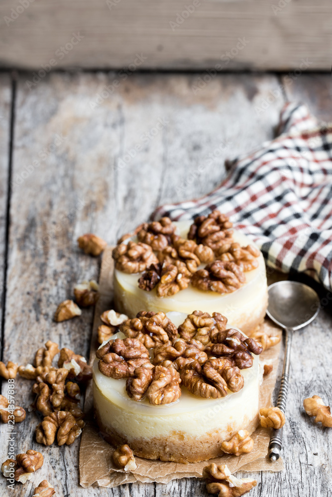 Two mini walnut cheesecake on wooden table Two mini walnut cheesecake on wooden table