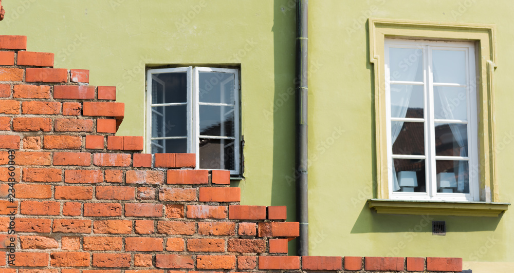 The city wall of warsaw with an old house
