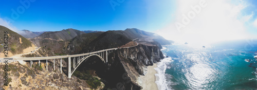 Aerial panoramic view of historic Bixby Creek Bridge along world famous Pacific Coast Highway 1 in summer sunny day , Monterey County, California, USA, shot from drone