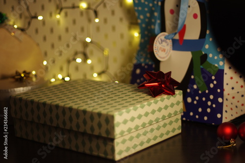 Ornamental gift box with red ribbon on top
