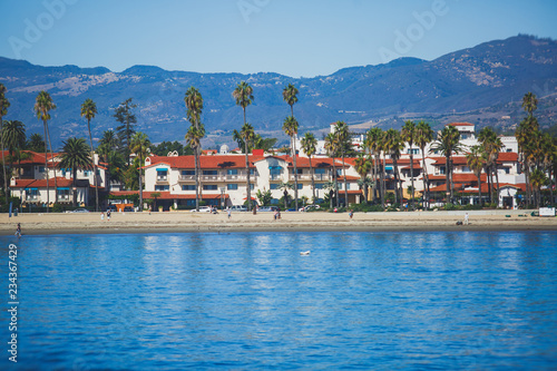 Beautiful view of Santa Barbara ocean front walk, with beach and marina, palms and mountains, Santa Ynez mountains and Pacific Ocean, Santa Barbara county, California, United States, summer sunny day