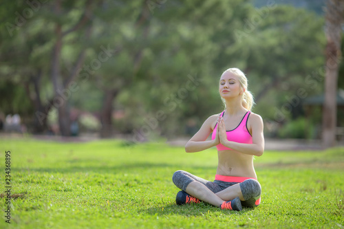 young girl doing yoga in the garden in spring