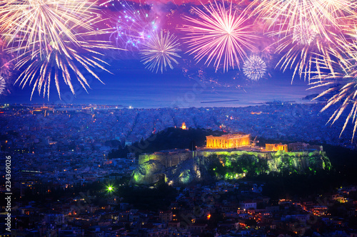 cityscape of Athens with illuminated Acropolis hill and Pathenon temple at night with fireworks, Greece