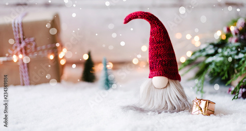 Frohe Weihnachten - Kleiner Wichtel zwischen Geschenken, Schnee und weihnachtlicher Dekoration im Winter 