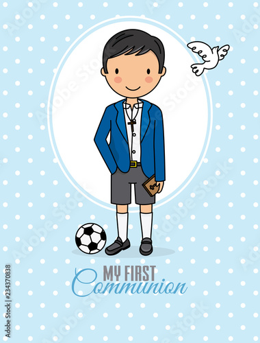 my first communion boy. Boy in communion costume and soccer ball
