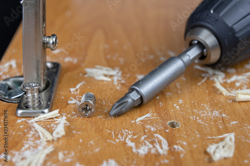 Installation of chipboard furniture in a carpentry workshop. Accessories and tools for carpenters.