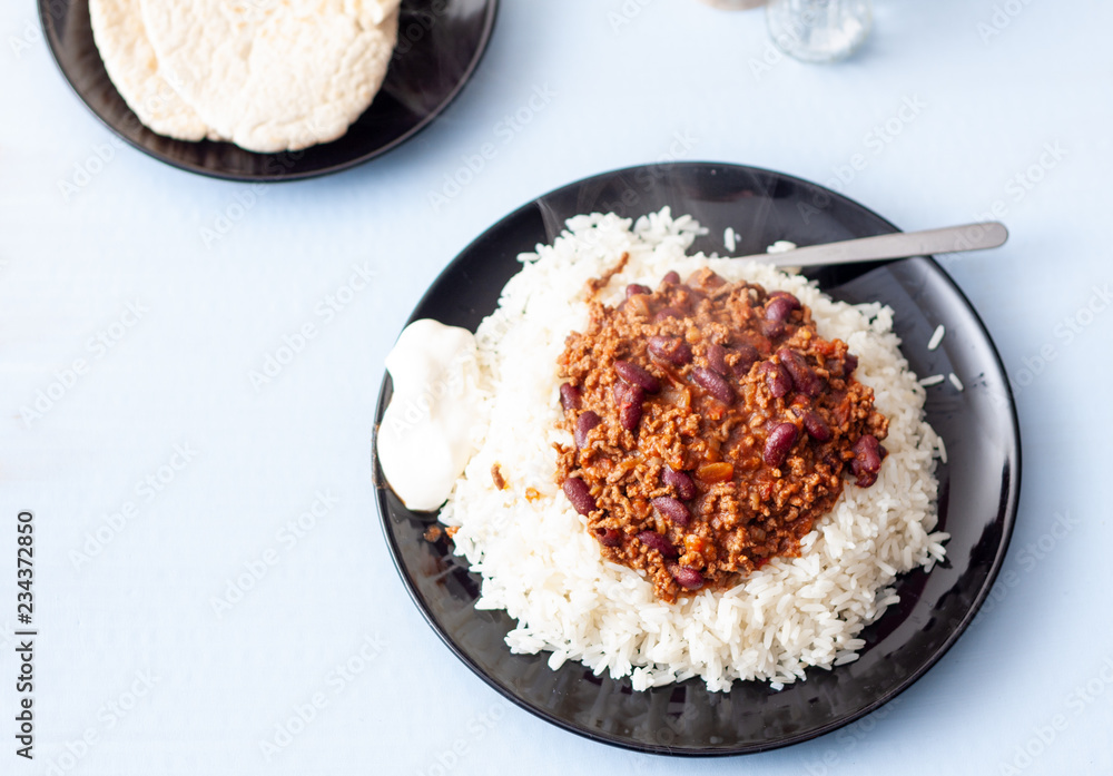 A plate of home-made chilli con carne with white long grain rice A plate of home-made chilli con carne with white long grain rice