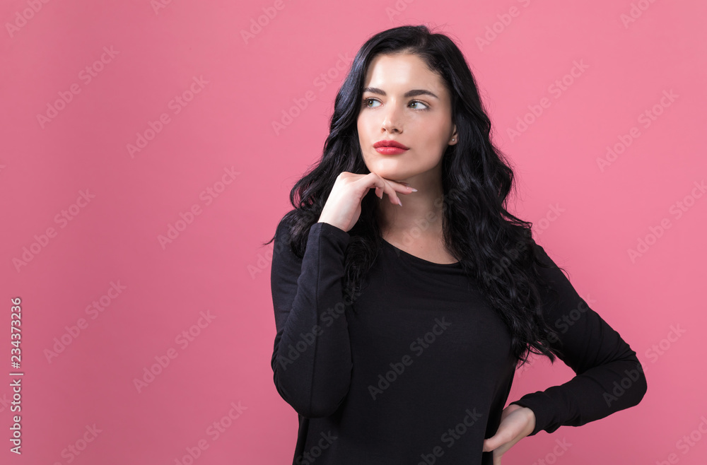 Beautiful young woman on a pink background Beautiful young woman on a pink background