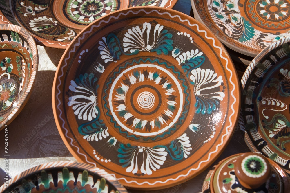 traditional Ukrainian ceramic clay plates, handmade and handpainted, bright floral and abstract pattern