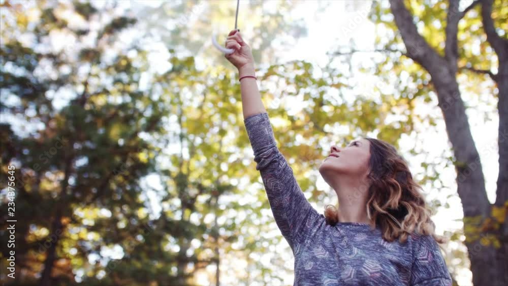 Beautiful woman in autumn forest playing with transparent umbrella Beautiful woman in autumn forest playing with transparent umbrella