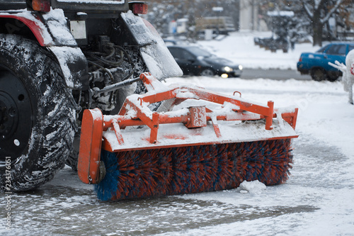 Tractor cleans snow brush