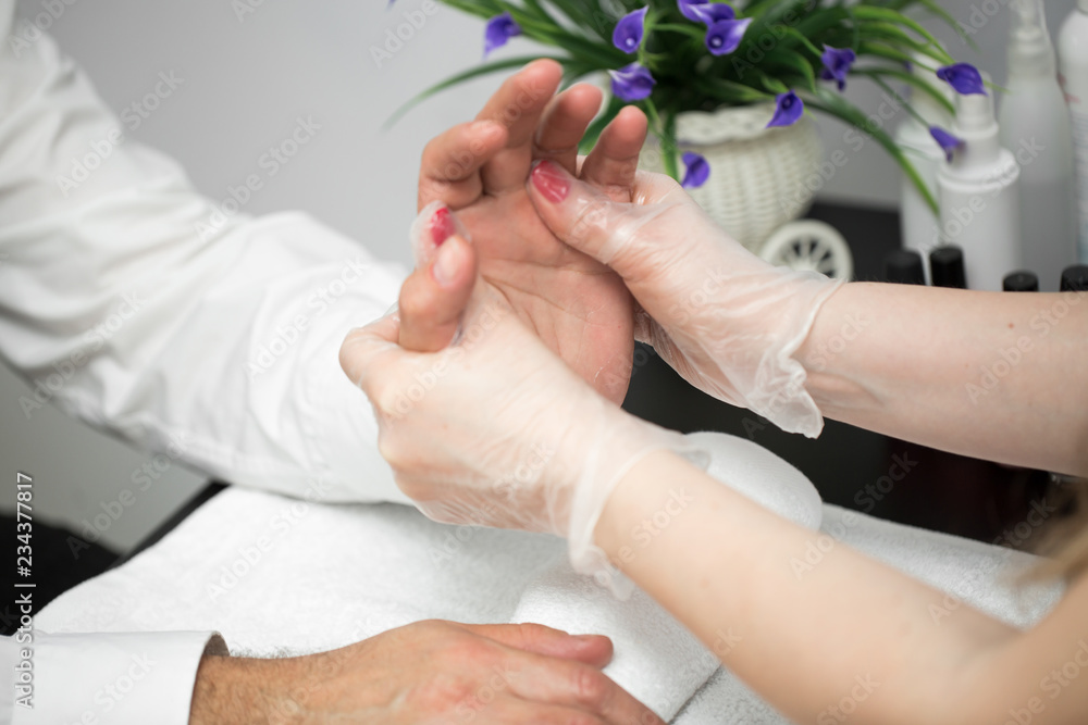 Fototapeta premium Massage after the manicure. Male and female hands macro.
