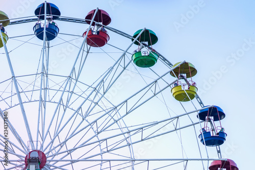 Ferris wheel in amusement park in blue sky background