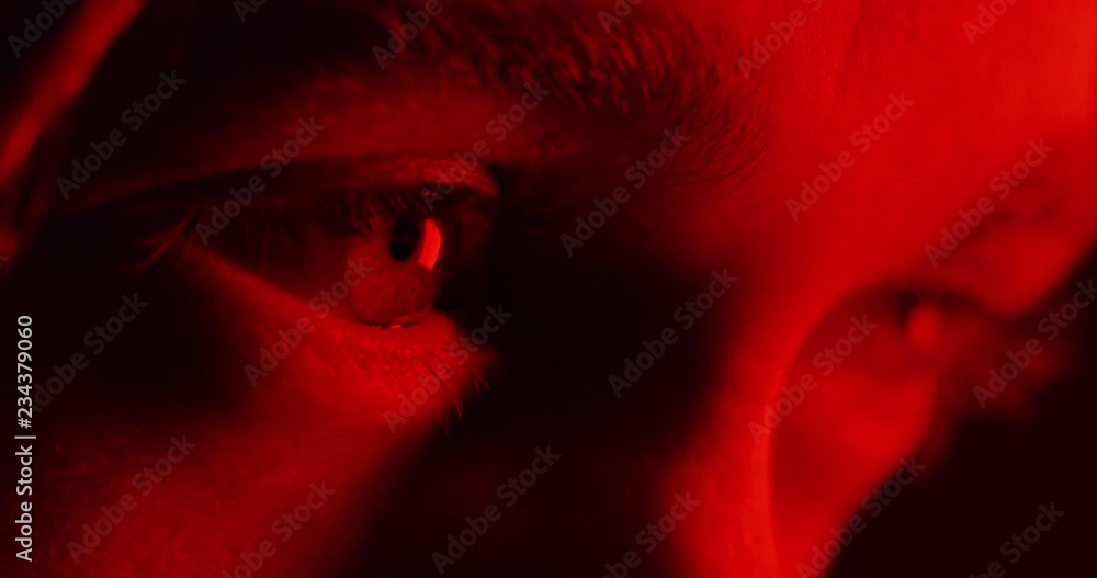 close up macro eyes opening looking at  intense red light 