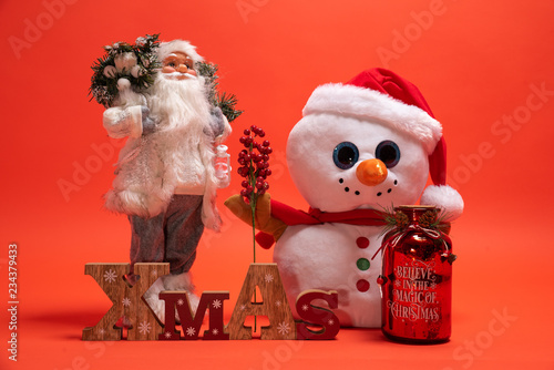 Santa Claus, Snoman toy and wooden Xmas text sign. Seasonal presents for December holiday photo