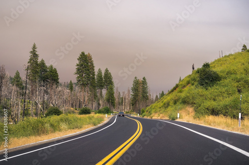 Driving through Yosemite National Park; filtered light due to the smoke coming from Ferguson Fire covering the sky, California photo