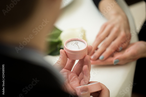 Man making marriage proposal to girlfriend at restaurant  closeup