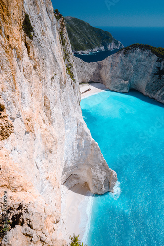 Limestone chalk colored like huge cliff rocks surrounding Navagio beach with Shipwreck and azure blue sea water. Zakynthos island, Greece photo