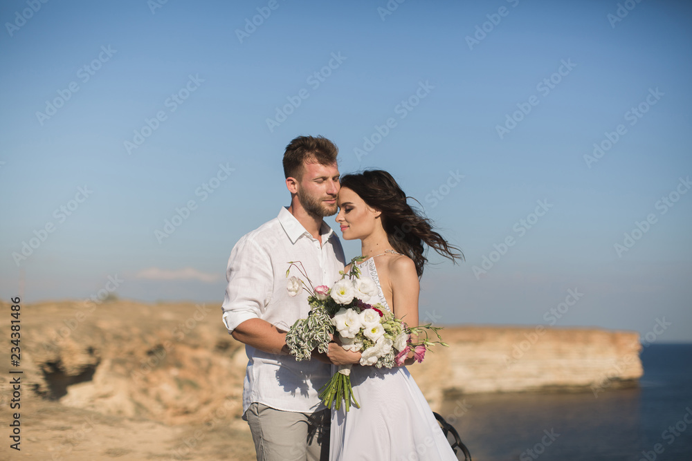Beautiful young couple on a date. The guy hugging and kissing a girl. Beautiful young couple on a date. The guy hugging and kissing a girl.