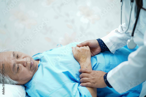 Holding Touching hands Asian senior or elderly old lady woman patient with love, care, helping, encourage and empathy at nursing hospital ward : healthy strong medical concept 