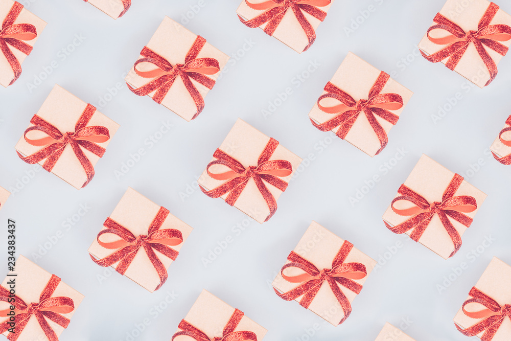 Seamless pattern of craft boxes with red ribbon bows. Valentine day concept. Trendy minimalistic flat lay design background in pop art style Seamless pattern of craft boxes with red ribbon bows. Valentine day concept. Trendy minimalistic flat lay design background in pop art style