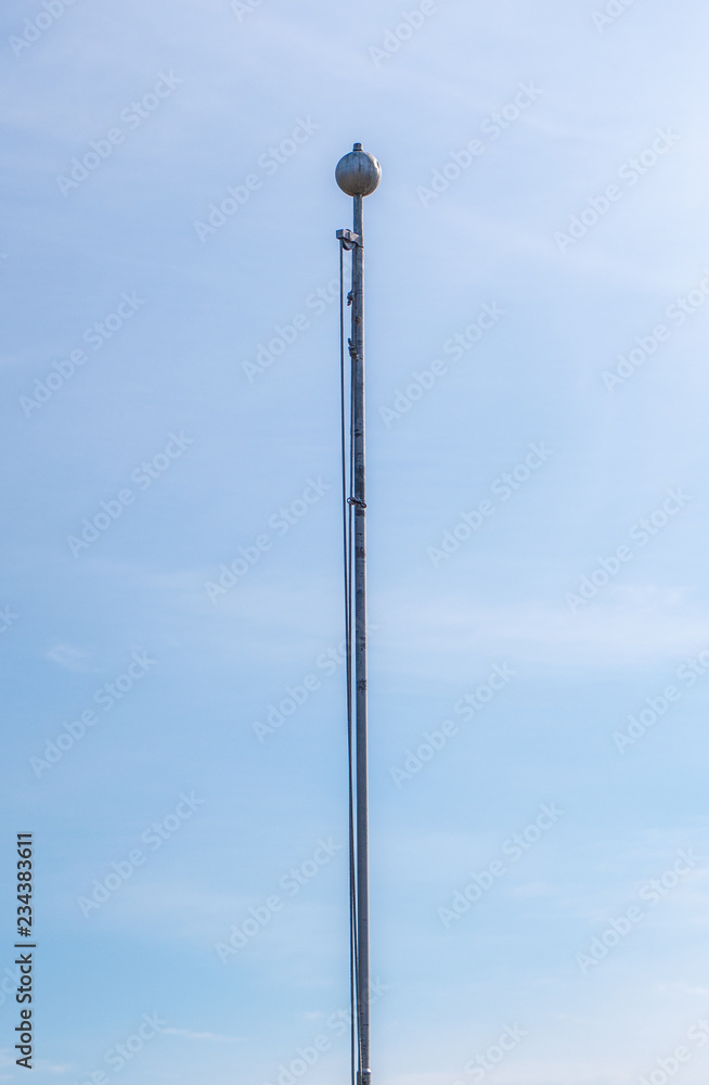 Empty flag pole against blue sky