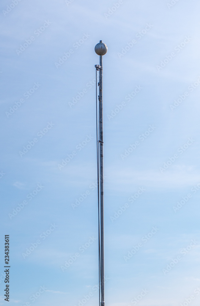 Empty flag pole against blue sky Empty flag pole against blue sky