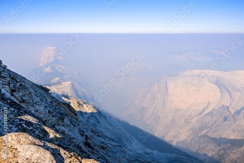 View towards Half Dome and the valley beyond on a day with low visibility due to the smoke coming from the Ferguson Fire, Yosemite National Park, California photo