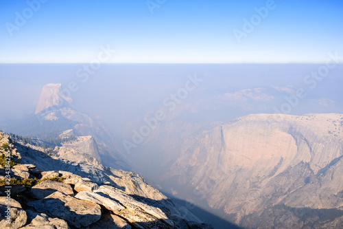 View towards Half Dome and the valley beyond on a day with low visibility due to the smoke coming from the Ferguson Fire, Yosemite National Park, California photo