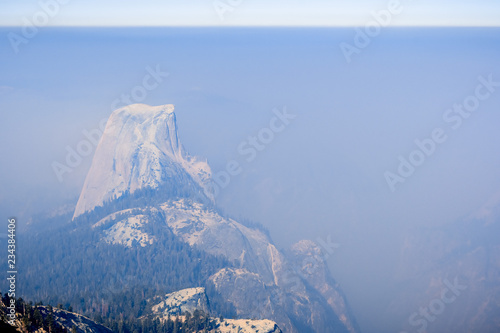 View towards Half Dome and the valley beyond on a day with low visibility due to the smoke coming from the Ferguson Fire, Yosemite National Park, California photo