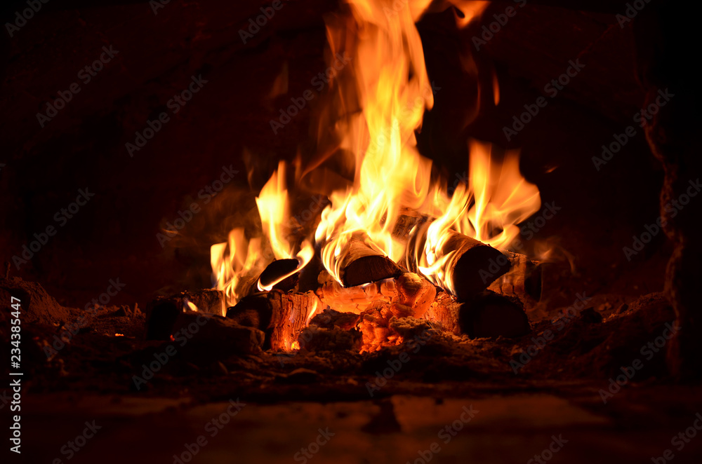 hot flaming wood in the hearth close-up-background image hot flaming wood in the hearth close-up-background image
