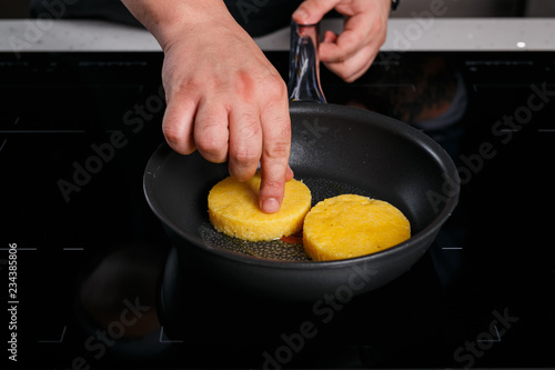 Chef frying polenta