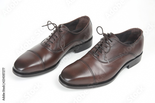 Classic men's brown Oxford shoes on white background. Leather shoes © photosaint