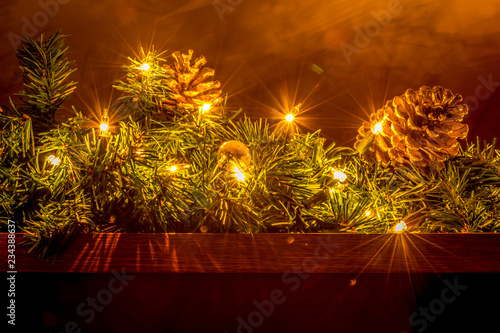 Christmas holiday lighting and decorations on a fireplace mantle.